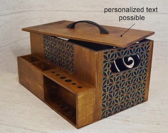 May include: Wooden storage box with a hinged lid, a black handle, and a geometric pattern on the front. The box has compartments for organising small items. The lid has space for personalised text.