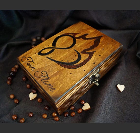 A handmade engraved wooden keepsake box with a lock and twin flame symbol — a deeply personal, one-of-a-kind love token that feels genuinely crafted.