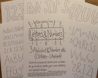 May include: Three sheets of paper with black and white outlines of letters and numbers. The sheets are titled "Letters & Numbers" and include the text "3 Alphabet & Number sets... (2 Stitchery + 1 Applique)".
