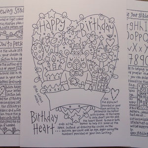 May include: A black and white printable design for a birthday card featuring a heart shape with a birthday cake, a bear, and the words "Happy Birthday". The design includes instructions for sewing and stitching, along with an alphabet and numbers for personalisation.