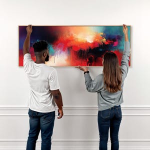 May include: A large rectangular canvas wall art piece featuring an abstract composition with vibrant blends of red, orange, yellow, and deep blue. The painting displays textured paint drips and a light-coloured wooden frame, creating a bold visual statement.