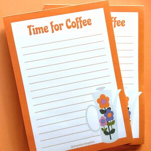 May include: Two orange lined notepads with the text "Time for Coffee" on the top. The notepad on the left has a white illustration of a coffee pot with flowers on it. The bottom of the notepad has the text "@shopdebvintagedeco".