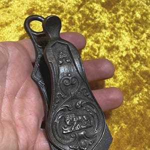 Antique paper clip paperweight desk document note holder. Victorian steel letter stationary clip with lion design.