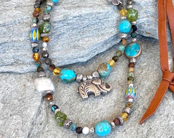 Sundance style Turquoise, freshwater Pearls and Leather necklace.  Two tiers of gemstones Turquoise, Pearls and Peridot.  Hilltribe Elephant