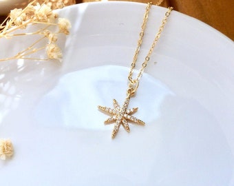 North star pendant necklace with zirconiums mounted on a gold-plated brass chain