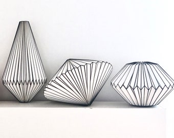 Origami lamp made of paper folded black and white