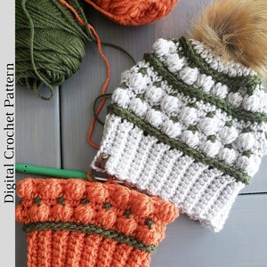 May include: A close-up of two crocheted hats. One hat is gray with green and white accents, and the other is orange with green accents. The hats are on a gray wooden surface. "Digital Crochet Pattern" is written on the left side of the image.