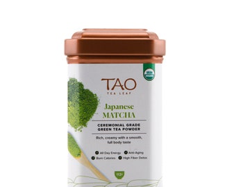 May include: A copper-colored tin container of Tao Tea Leaf Japanese Ceremonial Grade Green Tea Powder. The label features the brand name, product description, and USDA Organic certification. The tin contains 113 grams of green tea powder.