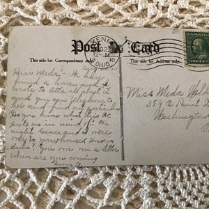 May include: A vintage postcard with a handwritten message. The message reads: "Dear Meda, I today found a house and wrote to tell all about it and you can telephone this and find out particulars. Do you know what this ac puts me in mind of... I might because I were ready to go and I more.  I will you on me a letter. When are you coming. Your B."