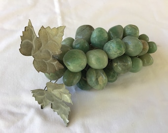 May include: A green jade stone grape cluster with two silver leaves.