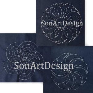 May include: Three dark blue fabric squares featuring white stitched geometric patterns. Each square displays a unique circular design created with dashed lines. The text SonArtDesign is overlaid on the fabric pieces in a white serif font.