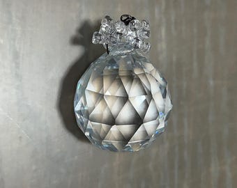 May include: A clear crystal ball with a faceted design, hanging from a silver chain with a crystal cluster at the top.