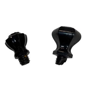May include: Two black, decorative cabinet knobs with a glossy finish. Each knob has a faceted, rounded top and a threaded screw base for attachment. The knobs are designed for furniture or cabinetry.