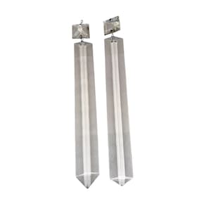 May include: Two clear crystal chandelier prisms. Each prism is rectangular with a pointed bottom and a square top. A wire loop is attached to the top square. The prisms are suspended against a white background.