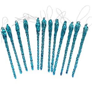 May include: A collection of twelve turquoise-colored, glass icicle ornaments. Each ornament has a twisted design and a loop for hanging. The ornaments are arranged against a white background, ideal for holiday decor.