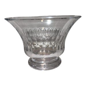 May include: A clear glass bowl featuring a wide, flared rim and a circular base. The exterior surface of the bowl is decorated with a repeating vertical pattern of pressed, rounded arches that create a textured, scalloped appearance.