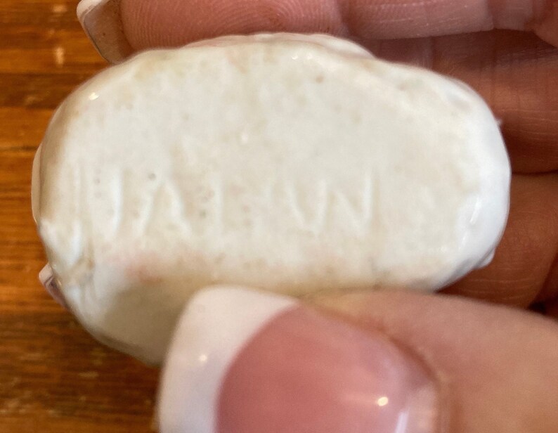 May include: Close-up of a white ceramic object with the word "JAPAN" embossed on the surface.