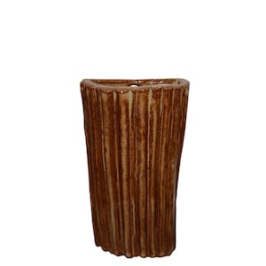 May include: A tall, brown ceramic vase with a textured, vertical ribbed design. The vase has a slightly flared top and a rounded base. The colour is a warm, earthy brown, suitable for home decor.