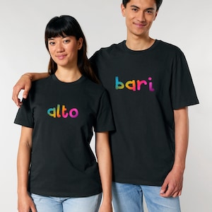 May include: Two people wearing black t-shirts with rainbow colored text. The text on the left shirt says "alto" and the text on the right shirt says "bari".
