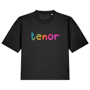 May include: Black cropped t-shirt with the word "tenor" printed in rainbow colors.