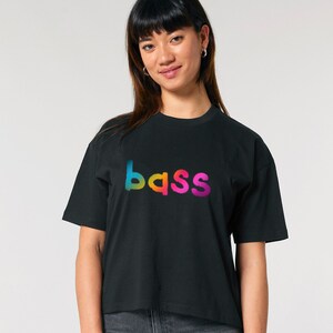 May include: A black cropped t-shirt with a rainbow gradient "bass" graphic.