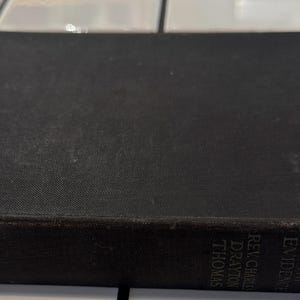 May include: A vintage hardcover book with a black cover. The book's spine displays the title "Life Beyond Death With Evidence" and the author's name. The book is rectangular and appears to be well-worn, with visible signs of age.