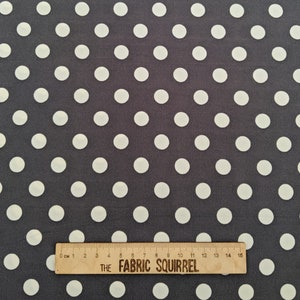May include: A dark grey fabric with a white polka dot pattern. The fabric is measured with a ruler that reads "THE FABRIC SQUIRREL".