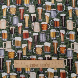 May include: A green fabric with a repeating pattern of various beer glasses, mugs, and steins. The fabric features a ruler with the text "The Fabric Squirrel" printed on it.