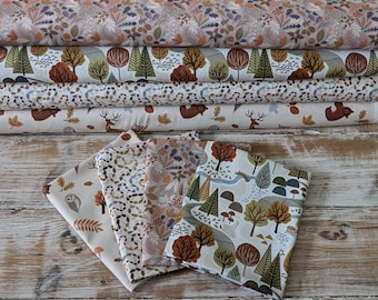 May include: A set of five fabric panels featuring a woodland theme with various animals, trees, and leaves in shades of brown, green, and beige. The panels are arranged on a wooden surface with a ruler labelled "The Fabric Squirrel".