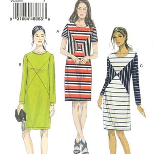 May include: Vogue Patterns sewing pattern V9240 featuring three dress designs. The pattern includes a green long-sleeve dress, a red, black, and white striped dress, and a white and navy striped dress. The pattern size is E5 (14-16-18-20-22).
