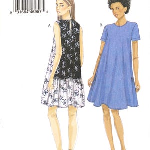 May include: A sewing pattern from Very Easy Vogue, V9237, featuring two dress designs. One dress has a black and white floral print, and the other is a solid blue. The pattern includes sizes Lrg-Xlg-XXl.