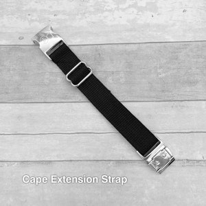 May include: Black adjustable strap with silver metal buckles. Cape Extension Strap.