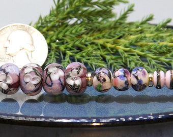 Four matching encased floral beads, & five supporting beads and four spacer beads - thirteen beads total