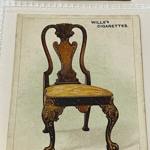 May include: A vintage illustration of a walnut chair with a carved wooden frame and a padded seat. The chair has a high back with a decorative design. The image is from a Wills's Cigarettes advertisement.