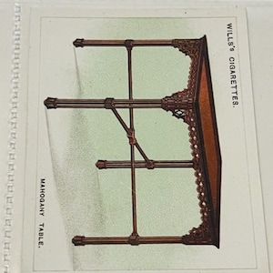 May include: A vintage illustration of a mahogany table with intricate details. The image is from a Wills's Cigarettes advertisement.