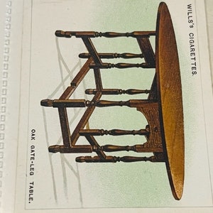 May include: A vintage illustration of an oak gate-leg table with a round top. The table is made of wood and has a brown finish. The image is from a Wills's Cigarettes card.