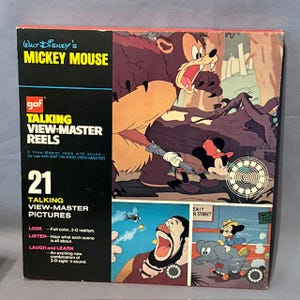 May include: A vintage Walt Disney's Mickey Mouse Talking View-Master Reels box. The box features colorful illustrations of Mickey Mouse and other characters. The box includes the text "21 Talking View-Master Pictures" and "Full colour, 3-D realism."