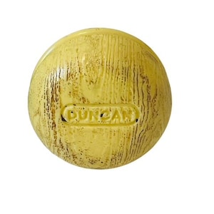 May include: A yellow rubber ball with a wood grain texture and the word "DURACAN" embossed on the surface.