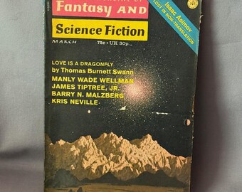 May include: A vintage March issue of "The Magazine of Fantasy and Science Fiction." The cover features a night sky with mountains and a road, with the magazine title in red and yellow. The cover also includes the names of the authors and the text "Lost in Non-Translation" by Isaac Asimov.