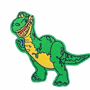 Puede incluir: Personaje de dinosaurio verde con vientre amarillo y una gran sonrisa. El dinosaurio está de pie sobre dos patas y tiene una cola larga.