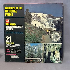 May include: A vintage GAF Talking View-Master Reels set, showcasing "Wonders of the National Parks." The box features images of mountains, waterfalls, and caves. The text on the box reads "21 Talking View-Master Pictures" and includes the phrases "Look, Listen, Laugh and Learn."