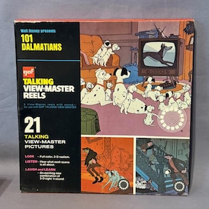 May include: A vintage 101 Dalmatians Talking View-Master Reels box. The box features illustrations of the animated film, including Dalmatian dogs and scenes from the movie. The box also includes text that reads "21 Talking View-Master Pictures."