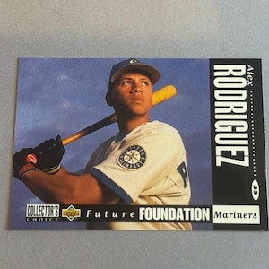 May include: Baseball card featuring Alex Rodriguez of the Seattle Mariners. The card shows Rodriguez in his Mariners uniform, holding a baseball bat. The card includes the text "COLLECTOR'S CHOICE" and "FUTURE FOUNDATION".