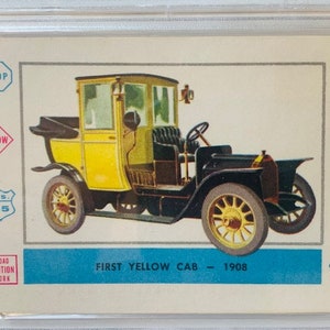 May include: A vintage yellow taxi cab from 1908. The cab has a black top and black wheels. The cab is on a white background with various road signs and traffic signals.