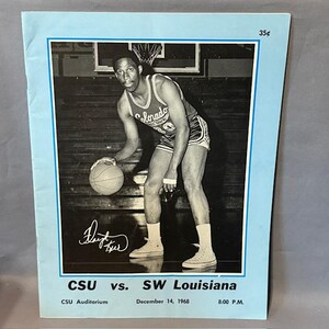 May include: A vintage basketball program with a black and white photo of a basketball player in a Colorado jersey dribbling a ball. The program is blue with text that reads "CSU vs. SW Louisiana" and "December 14, 1968". The price is 35¢.
