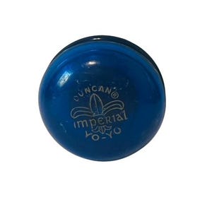 May include: A blue Duncan Imperial yo-yo with a white logo featuring a fleur-de-lis and the text "Duncan Imperial Yo-Yo".