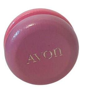 May include: A pink round wooden box with the word "AVON" embossed on the top.