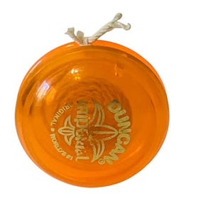 May include: Orange plastic yo-yo with a gold Duncan logo and "The Original" text. The yo-yo has a string attached.