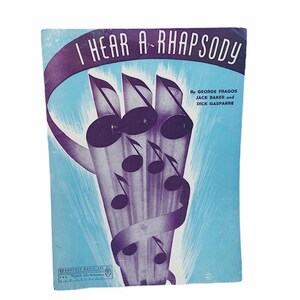 May include: A vintage sheet music cover for the song "I Hear a Rhapsody" by George Fragos, Jack Baker, and Dick Gasparre. The cover features a blue background with a purple musical note design.