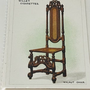May include: A vintage illustration of a walnut chair with a carved back and legs. The chair has a woven seat and is shown on a white background with the text "WILLS'S CIGARETTES." and "WALNUT CHAIR."